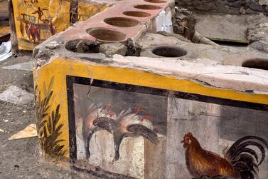 Frescoes on the counter of a Roman-era food stall, discovered during excavations in Pompeii, Italy. Pompeii Archaeological Park via Reuters