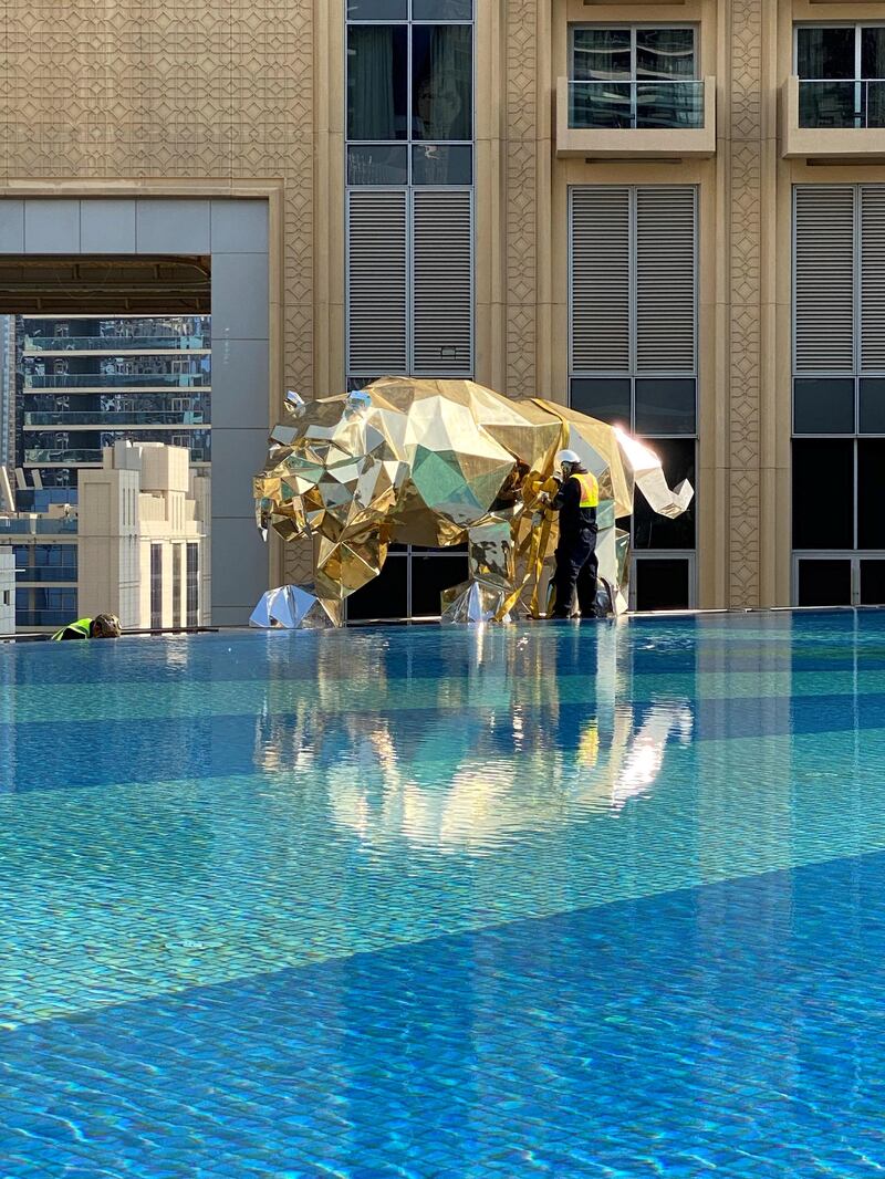 The golden tiger has been placed on the edge of the hotel's infinity pool.