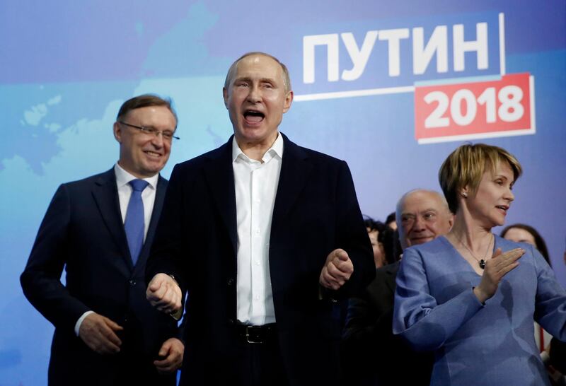 epa06613458 Presidential candidate, Russian President Vladimir Putin (C) reacts as he meets with his supporters at his campaign headquarters in Moscow, Russia, 18 March 2018. Russians are electing the President of Russia in the 18 March elections, with eight candidates contesting for the presidential seat, including the incumbent president Vladimir Putin, who leads with over 72 per cent of the vote and projected to win his fourth term in the Kremlin.  EPA/SERGEI ILNITSKY