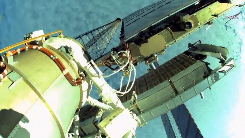 A sideview of the newly installed solar panels seen from US astronaut Shane Kimbrough's helmet camera. Five more rollout panels have still to be installed. AFP