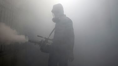 A health worker fumigates a residential area in Colombo, as Sri Lanka tries to curb dengue fever. Reuters