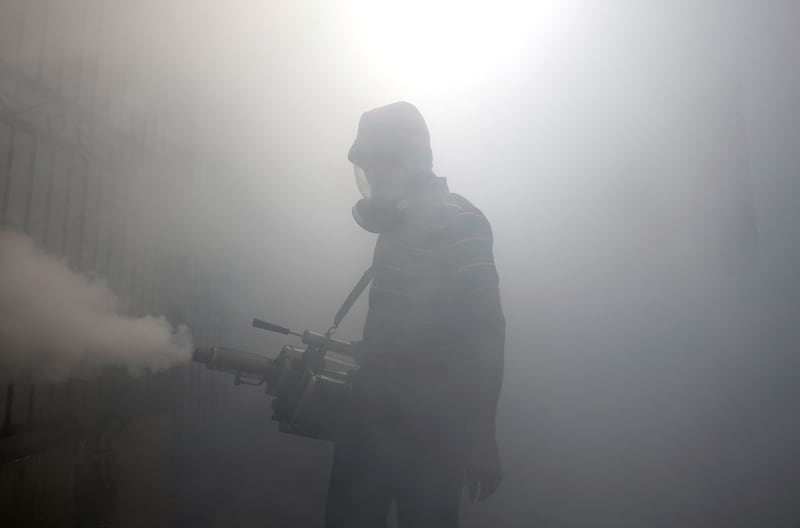 A health worker fumigates a residential area in Colombo, as Sri Lanka tries to curb dengue fever. Reuters