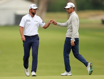 Cameron Young, left, fist-bumps Joaquin Niemann, of Chile, after hitting in for birdie on the 15th hole during the final round of the Genesis Invitational golf tournament at Riviera Country Club, Sunday, Feb.  20, 2022, in the Pacific Palisades area of Los Angeles. Photo: AP