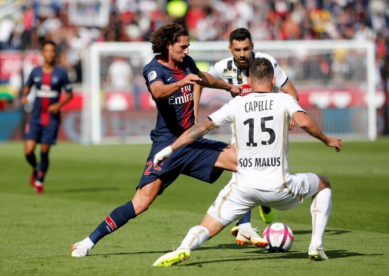 PSG's Adrien Rabiot, left, duels for the ball with Angers' Pierrick Capelle. AP Photo