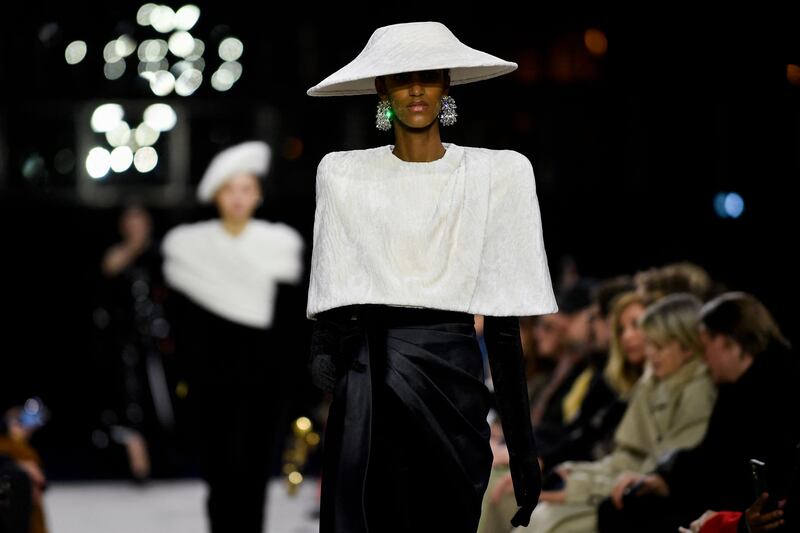 A short cape in watered silk at Balmain. AFP