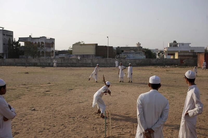 Muslim boys play cricket.