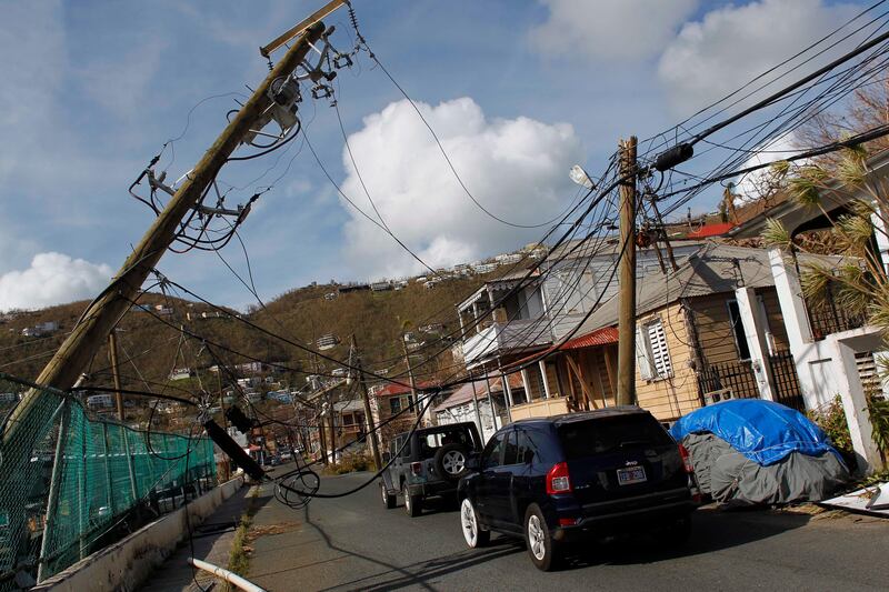 Power lines are damaged after the passage of Hurricane Irma in Charlotte Amalie, St. Thomas, U.S. Virgin Islands, Sunday, Sept. 10, 2017.  The storm ravaged such lush resort islands as St. Martin, St. Barts, St. Thomas, Barbuda and Anguilla. (AP Photo/Ricardo Arduengo)