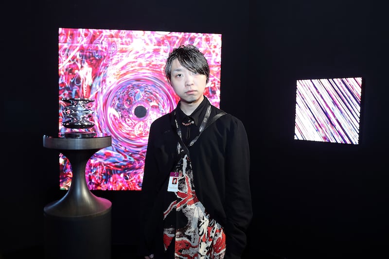 Yoichi Ochiai with his artwork at Art Dubai 