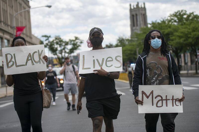 Protesters march with three placards stating "Black Lives Matter" in the aftermath of widespread unrest following the death of George Floyd on June 1, 2020 in Philadelphia, Pennsylvania. Getty