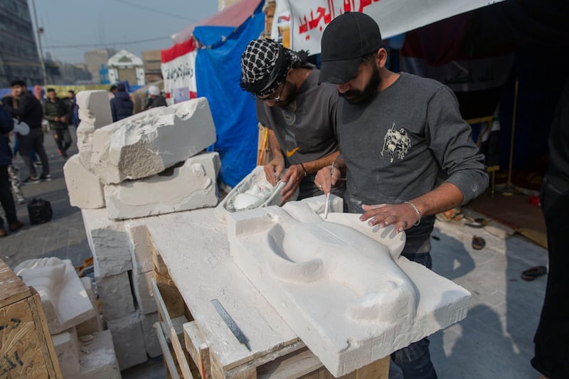 Young Iraqi trainees work on sculptures in preparation for their upcoming art exhibition during the ongoing protests in Tahrir square, Baghdad, Iraq. AP Photo