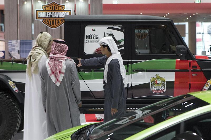 Visitors to the Life and Style show, which opened yesterday at Adnec, take a look at a patriotically decorated vehicle. Mona Al-Marzooqi / The National