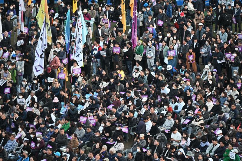 People attend a vigil in Seoul to mark the first anniversary of the tragic crowd crush that killed 159 people during Halloween celebrations. AFP
