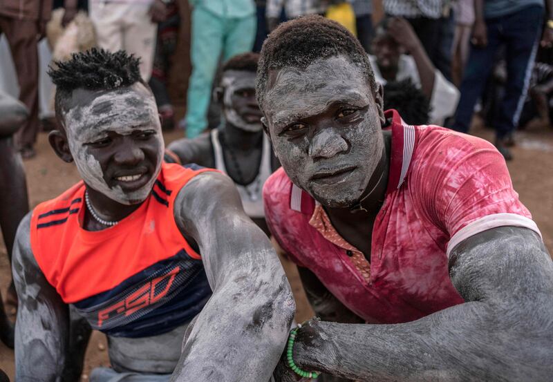 Wrestlers sit by the ring during a traditional Nuba wrestling competition in Sudan's capital Khartoum.