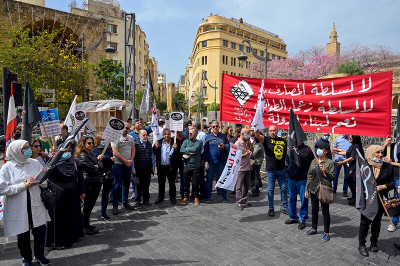 Lebanese Bank customers carry placards during a protest outside the Lebanese parliament in downtown Beirut, on April 19, 2022. EPA
