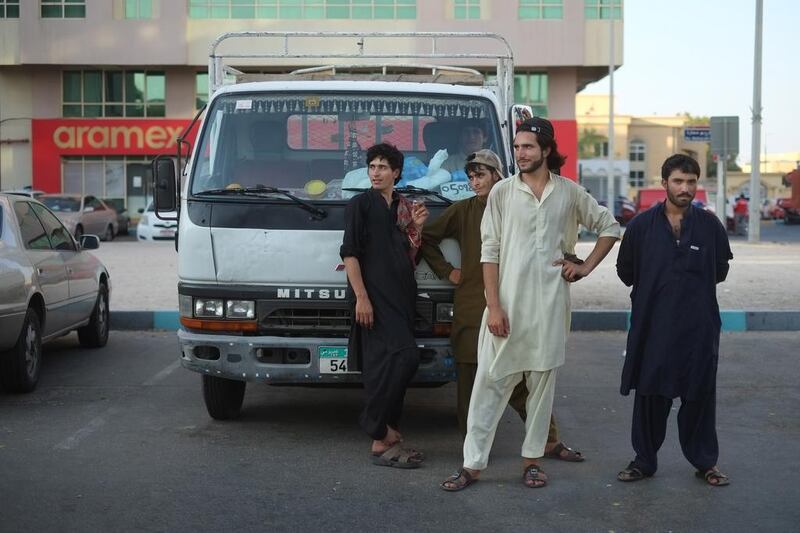 Labourers wait for work hauling furniture, appliances or anything where a truck and manpower is needed. Delores Johnson / The National 