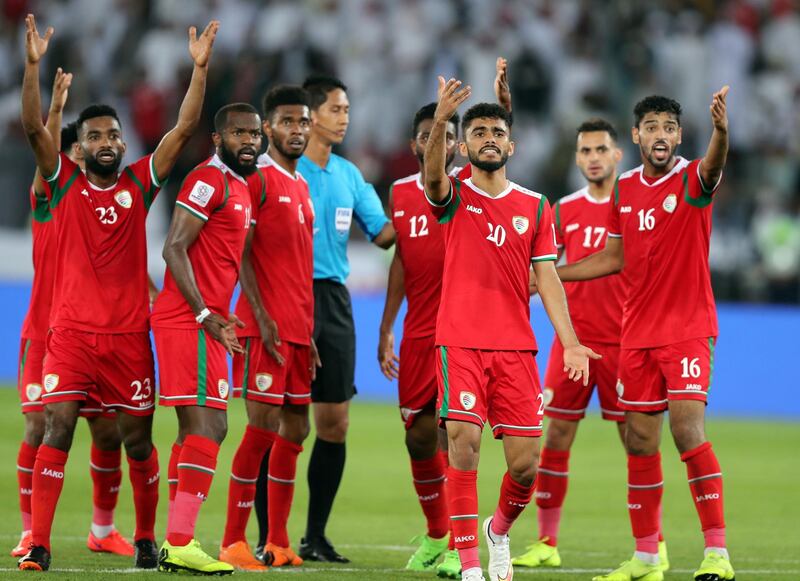 Abu Dhabi, United Arab Emirates - January 13, 2019: The Oman players complain after they think should have had a penalty during the game between Japan and Oman in the Asian Cup 2019. Sunday, January 13th, 2019 at Zayed Sports City Stadium, Abu Dhabi. Chris Whiteoak/The National