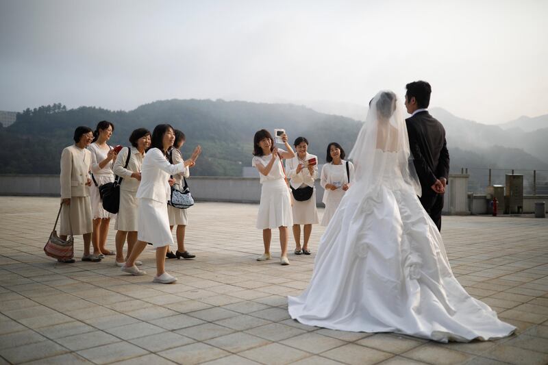 Relatives take photographs of a couple who took part in a mass wedding in South Korea. Kim Hong-ji / Reuters