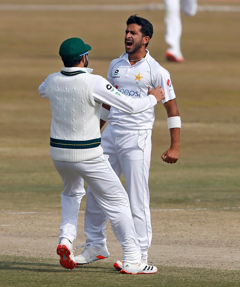 Pakistan's Hasan Ali, right, celebrates with teammates after taking the wicket of South Africa's Aiden Markram during the fifth day of the second cricket test match between Pakistan and South Africa at the Pindi Stadium in Rawalpindi, Pakistan, Monday, Feb. 8, 2021. (AP Photo/Anjum Naveed)
