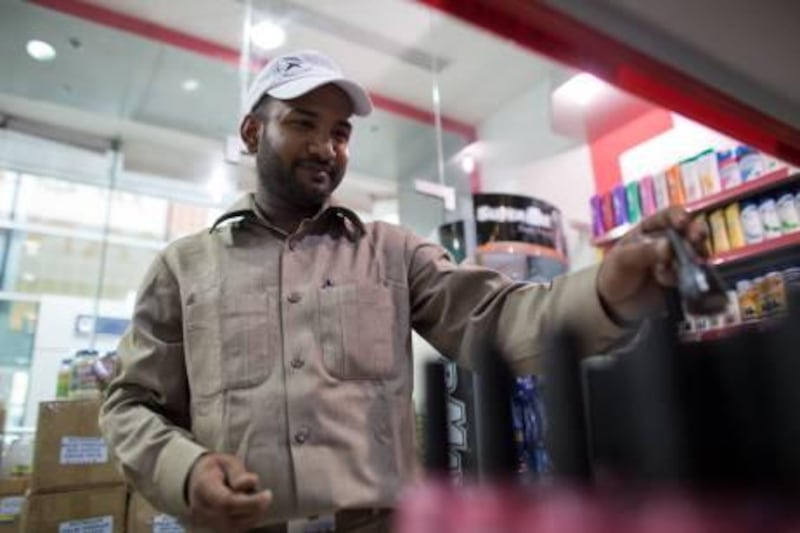 September 16, 2011 - Employee of Stop and Buy shop Sharif Jaman, 39 from Bangladesh puts stock away in the show which is in front of Salah Ul Din green line metro station in Dubai, UAE.  Jaman says profits have increased 60% since the construction has stopped and the metro station opened. Pawel Dwulit / The National