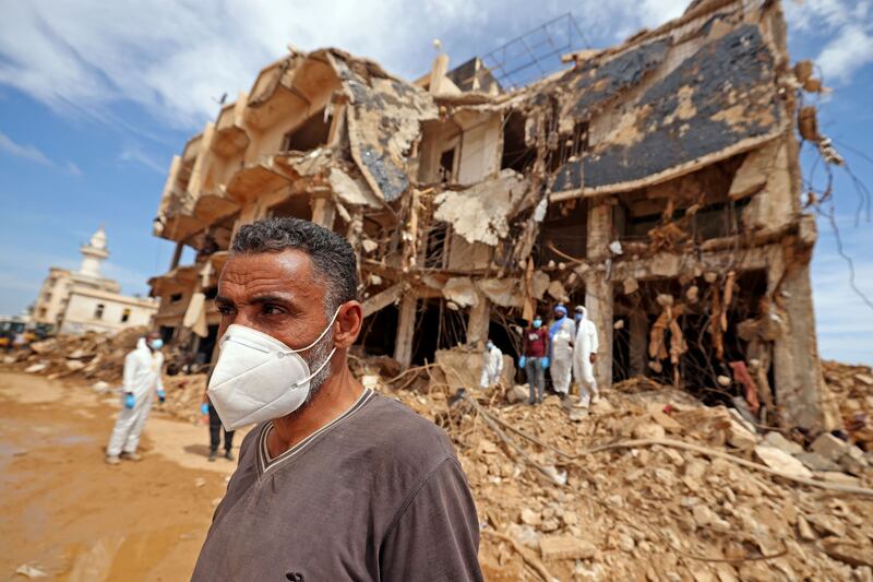 Rescue teams assist in relief work in Libya's eastern city of Derna on Sunday following deadly flash floods. AFP