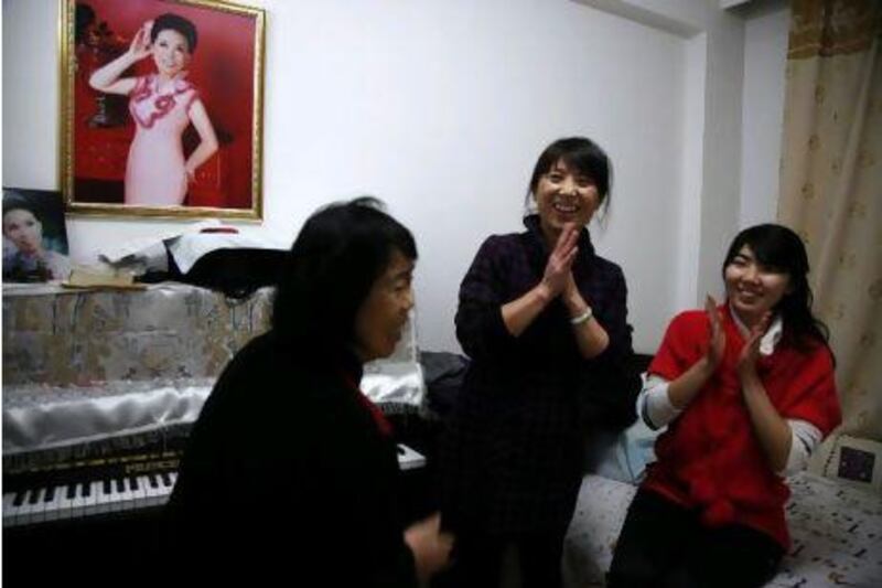 Mia Wang, right, with her mother Zheng Hong, centre, and aunt Zheng Chunfeng at their home in Benxi, north-eastern China. With women now accounting for half of full-time undergraduates, Ms Mia is part of the most educated generation of women in the nation's history. Ng Han Guan / AP Photo