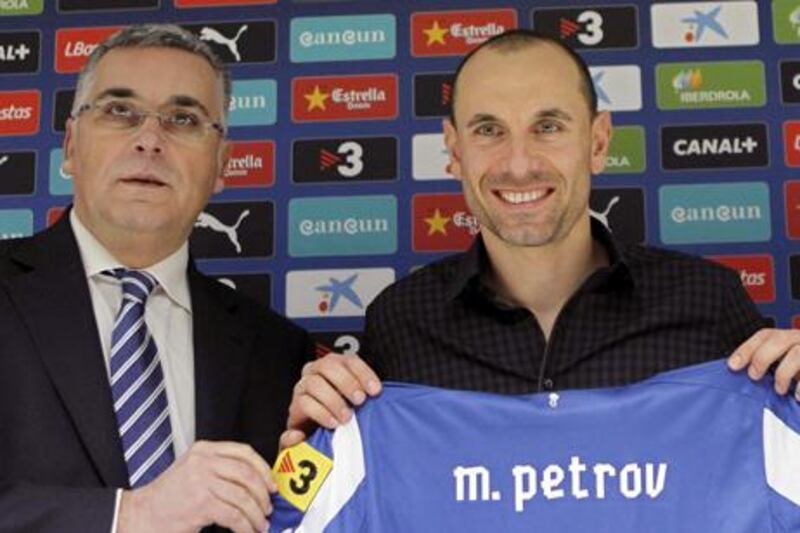 Martin Petrov displays his new Espanyol shirt with club president Joan Collet after signing on at the Spanish side.