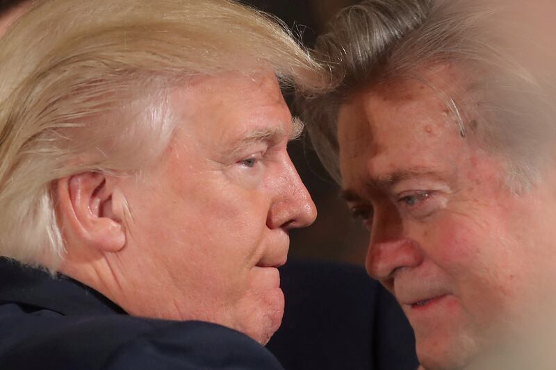 FILE PHOTO:  U.S. President Donald Trump talks to chief strategist Steve Bannon during a swearing in ceremony for senior staff at the White House in Washington, U.S. January 22, 2017. REUTERS/Carlos Barria/FILE PHOTO     TPX IMAGES OF THE DAY