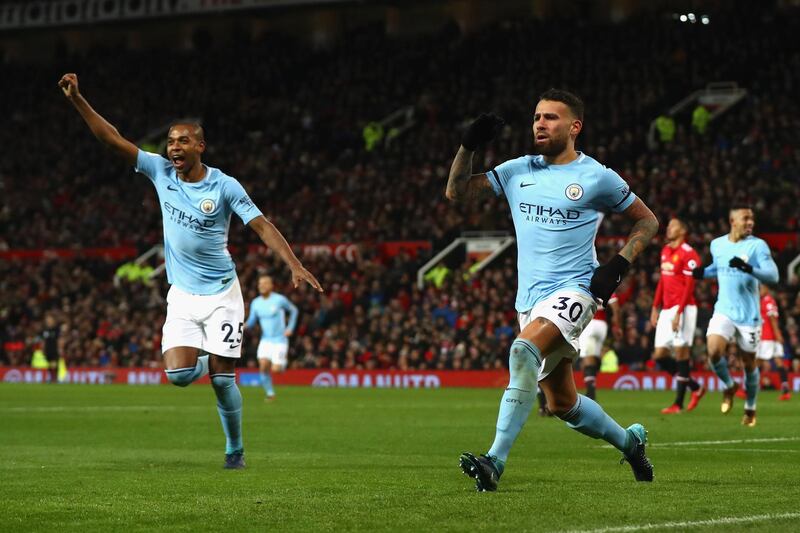 MANCHESTER, ENGLAND - DECEMBER 10:  Nicolas Otamendi of Manchester City celebrates scoring the 2nd Manchester City goal with Fernandinho during the Premier League match between Manchester United and Manchester City at Old Trafford on December 10, 2017 in Manchester, England.  (Photo by Michael Steele/Getty Images)