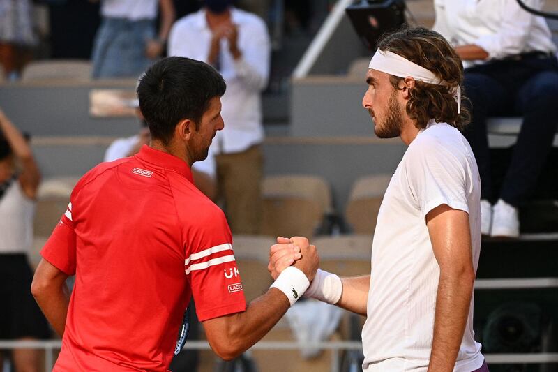 Novak Djokovic and Stefanos Tsitsipas shake hands at the net following the French Open final. AFP