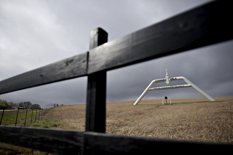 A pipeline sign stands in Cushing, Oklahoma, U.S., on Wednesday, March 25, 2015. The fastest oil-inventory growth on record at the main U.S. hub may be about to end, easing concern that storage limits will be strained. Photographer: Daniel Acker/Bloomberg