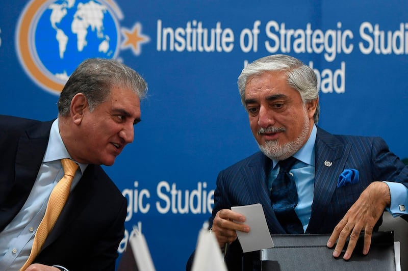 Pakistan's Foreign Minister Shah Mahmood Qureshi (L) speaks with Chairman of the High Council for National Reconciliation of Afghanistan Abdullah Abdullah during an event at the Institute of Strategic Studies, in Islamabad on September 29, 2020. The Afghan official overseeing Kabul's efforts to forge a deal with the Taliban arrived on September 28 for a three-day visit to Pakistan, the influential neighbour considered vital to the peace process. / AFP / Aamir QURESHI
