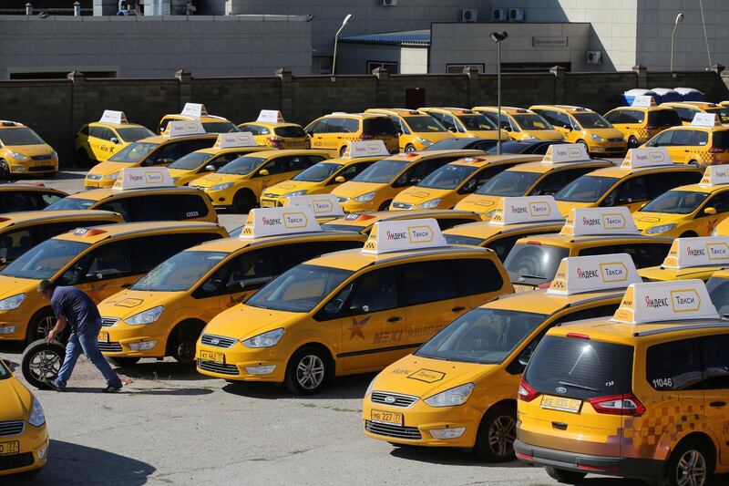 Yellow taxi cabs operated by the Nexi taxi service, a unit of ASAP Transportation Co. and connected through the Yandex.Taxi online app, sit in a parking bay ahead of use in Moscow, Russia, on Tuesday, Aug. 25, 2015. Yandex NV now has more than 15,000 taxis connected to its online-hailing application in Moscow, according to estimates by the city's Chamber of Commerce. Photographer: Andrey Rudakov/Bloomberg