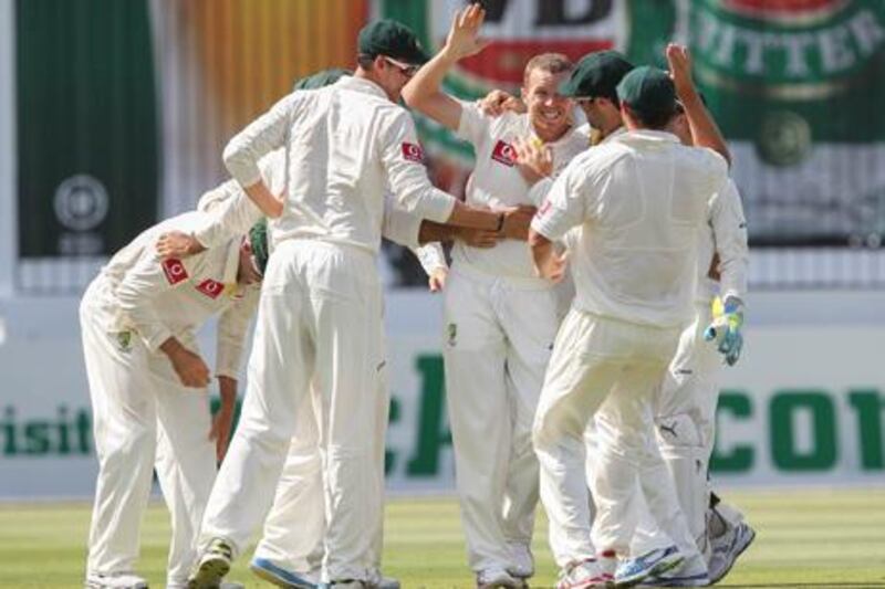 Australia's Peter Siddle is congratulated by teammates after taking a wicket against South Africa.