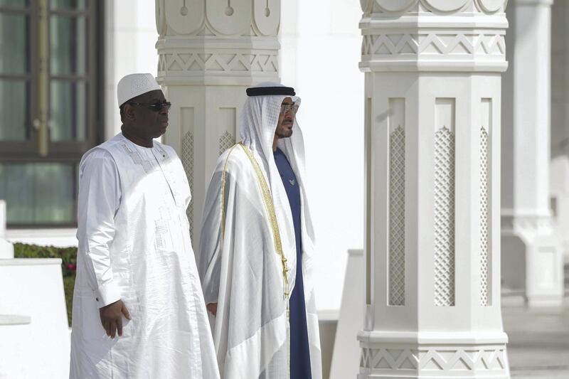 ABU DHABI, UNITED ARAB EMIRATES - February 06, 2020: HH Sheikh Mohamed bin Zayed Al Nahyan Crown Prince of Abu Dhabi Deputy Supreme Commander of the UAE Armed Forces (R) and HE Macky Sall, President of Senegal (L), stand for the national anthem during an official visit reception, at Qasr Al Watan. 

( Hamad Al Mansoori for the Ministry of Presidential Affairs )
---