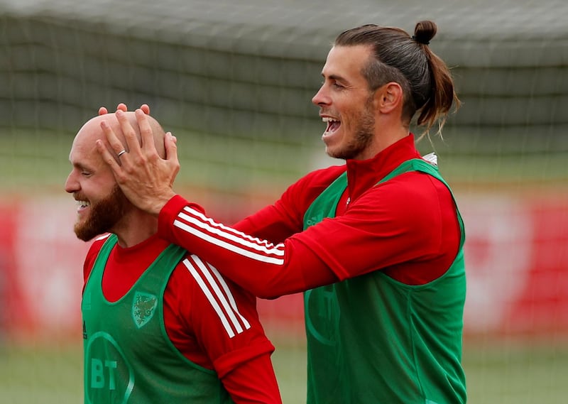 Gareth Bale shares a joke with Jonny Williams during training with Wales. Reuters