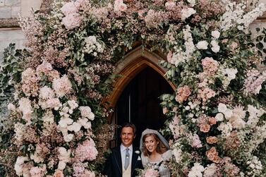 In this photograph released by the Royal Communications of Princess Beatrice and Edoardo Mapelli Mozzi, Britain's Princess Beatrice and Edoardo Mapelli Mozzi stand in the doorway of The Royal Chapel of All Saints at Royal Lodge, Windsor, England, after their wedding on Saturday July 18, 2020. Princess Beatrice wore a vintage dress loaned to her by Queen Elizabeth II at her wedding, Buckingham Palace said Saturday as it released official photographs from the small family event. (Benjamin Wheeler/Royal Communications of Princess Beatrice and Edoardo Mapelli Mozzi via AP)