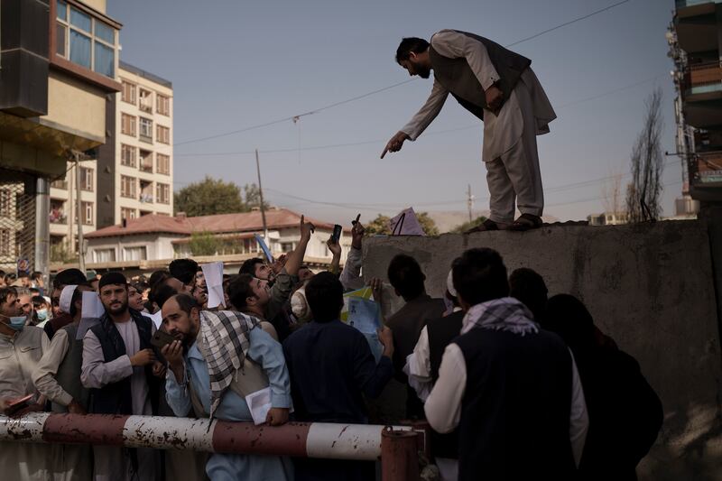 Afghans gather outside a passport office recently re-opened after the Taliban said they would deal with a backlog of applications approved by the previous administration in Kabul. Photo: AP