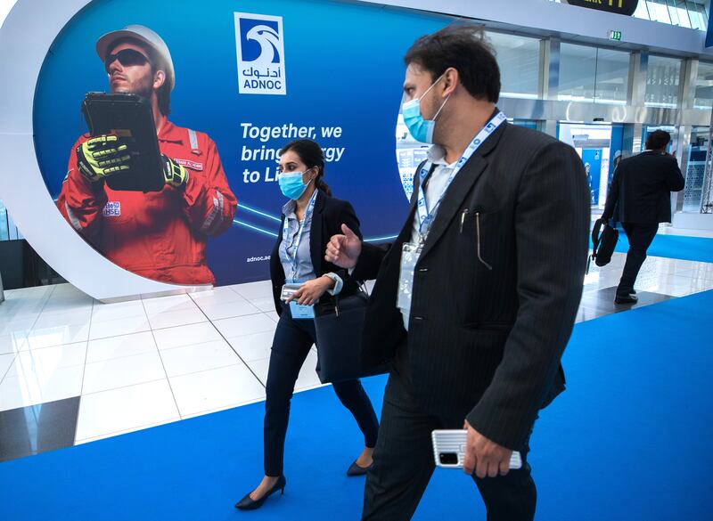 Visitors arrive for the first day of Adipec.