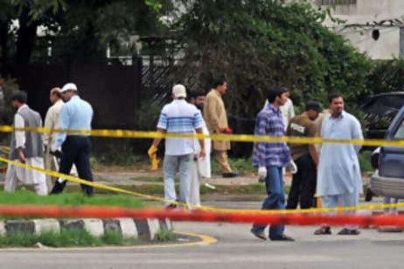 Pakistani investigators collect evidence at the suicide attack site in Islamabad.