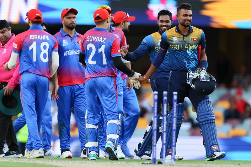 Dhananjaya de Silva, right, and Dasun Shanaka are congratulated by Afghanistan players. AP