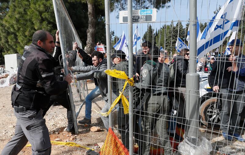 Police hold back protesters at an anti-government rally outside the Israeli parliament in Jerusalem on February 13. EPA