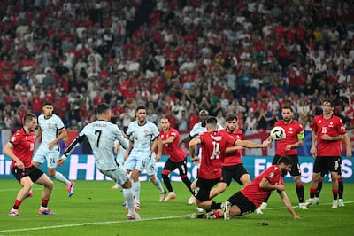 Georgia's players throw their bodies in the way of a shot by Portugal's Cristiano Ronaldo. AFP
