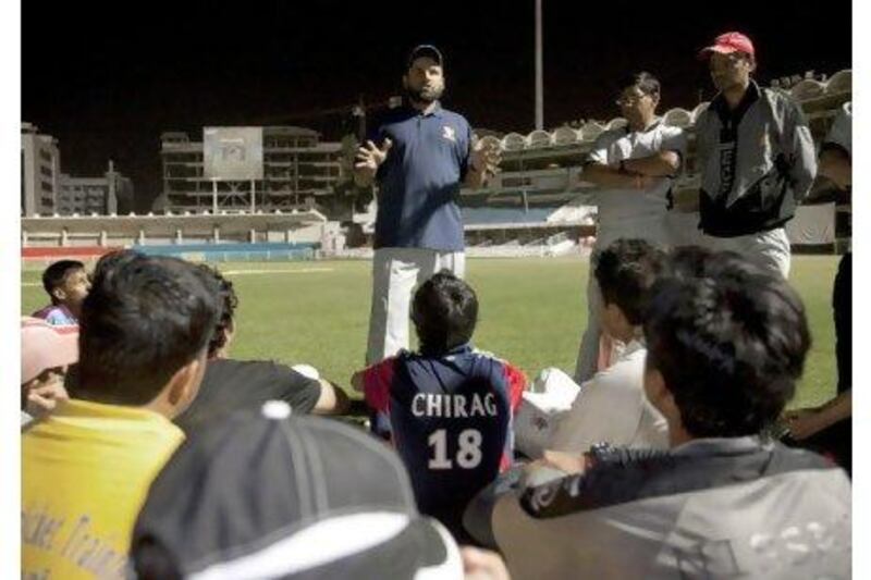 Kabir Khan talks to his players during a net session at Sharjah Cricket Stadium.