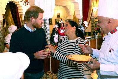 Britain's Prince Harry and Meghan, Duchess of Sussex, react after trying food as they visit a cooking school demonstration at the Villa des Ambassadors in Rabat, Morocco, Monday Feb. 25, 2019.  The royal couple sampled food, where children from under-privileged backgrounds learn traditional Moroccan recipes from one of Moroccos foremost chefs. (Tim P. Whitby/Pool via AP)