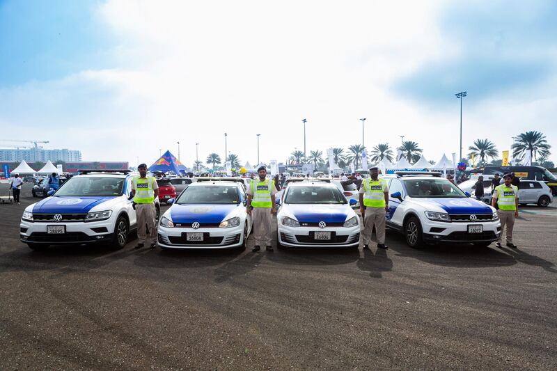 Abu Dhabi police officers stand by their vehicles before heading out with the 400-strong convoy.