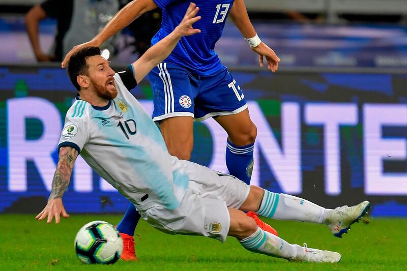 Argentina's Lionel Messi is fouled by Paraguay's Junior Alonso. AFP