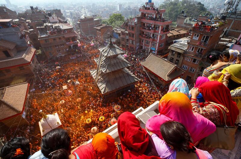 Nepalese people sing and dance to traditional music while smearing vermilion colour powder during the 'Sindoor Jatra' festival as part of the Bisket Jatra festival in Thimi, on the outskirts of Kathmandu, Nepal. Narendra Srestha / EPA