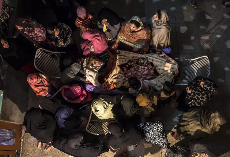 Women mourn as they surround the body of their relative Osama Taher, 15, a student who was killed during an attack by Taliban gunmen on the Army Public School, at his house in Peshawar on December 16. Zohra Bensemra / Reuters