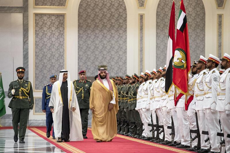 ABU DHABI, UNITED ARAB EMIRATES - November 22, 2018: HRH Prince Mohamed bin Salman bin Abdulaziz, Crown Prince, Deputy Prime Minister and Minister of Defence of Saudi Arabia (centre R), inspect the UAE Honour Guard during a reception at the Presidential Airport. Seen with HH Sheikh Mohamed bin Zayed Al Nahyan, Crown Prince of Abu Dhabi and Deputy Supreme Commander of the UAE Armed Forces (centre L). 
( Ryan Carter / Ministry of Presidential Affairs )
---