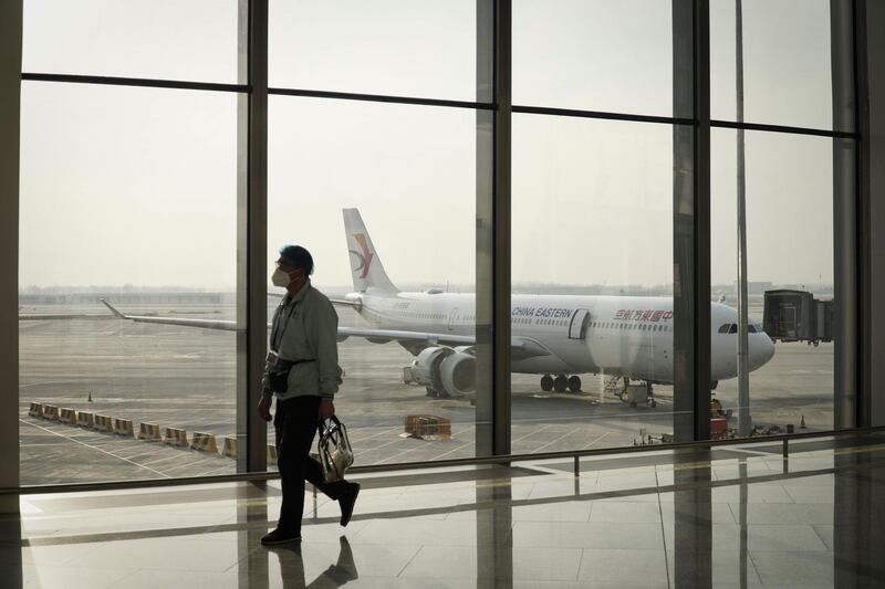 An airport worker walks along Daxing Airport in Beijing ahead of Lunar New Year, which falls on February 12.  AFP